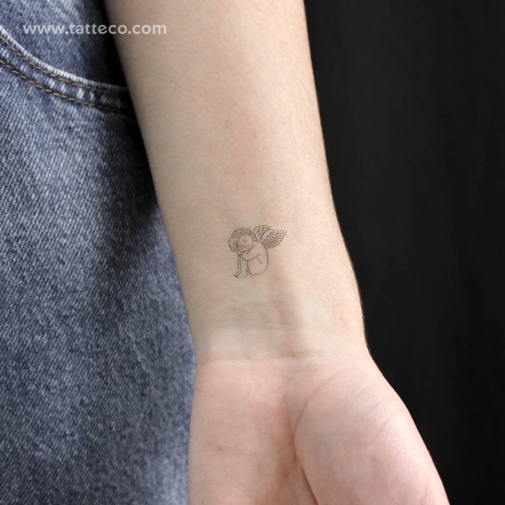 Cherub resting temporary tattoo located on the wrist.