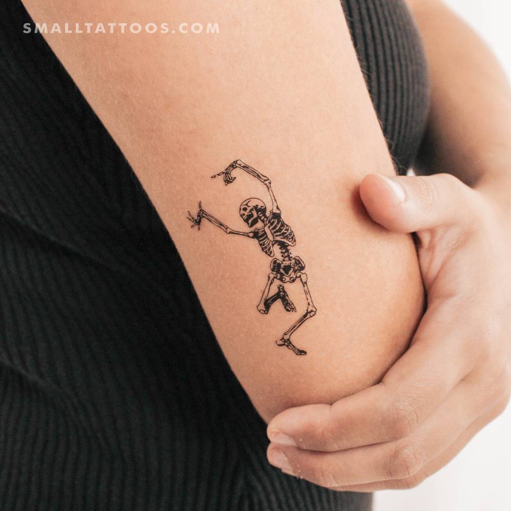 Dancing skeleton temporary tattoo located on the tricep.