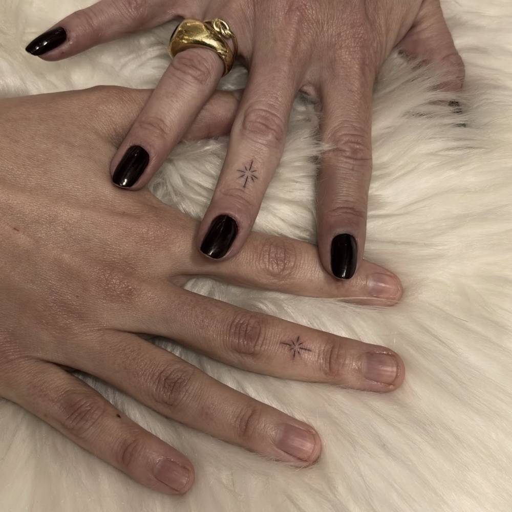 Matching minimalistic north star tattoo for couple.