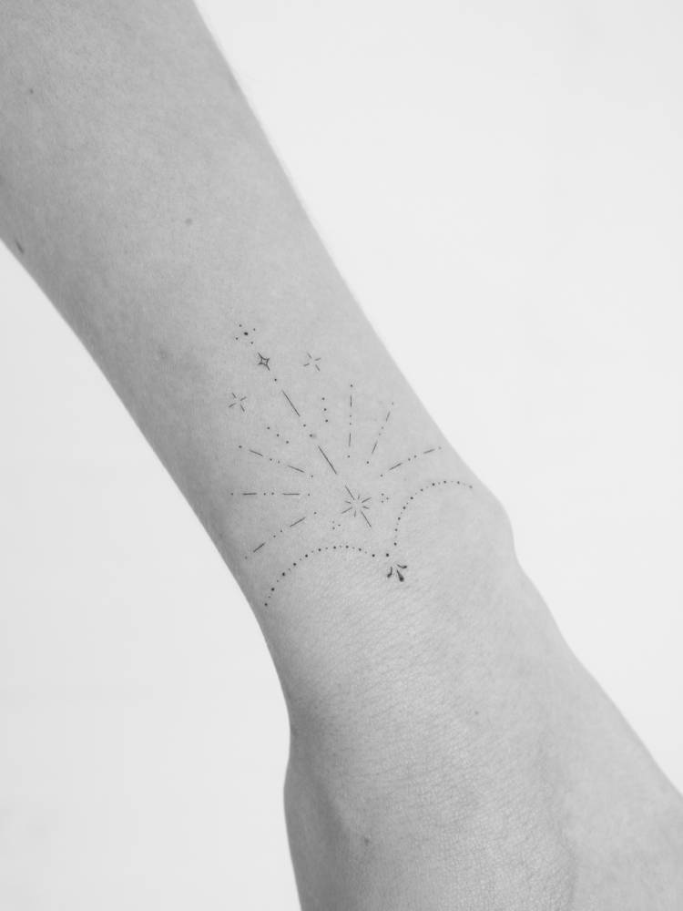 Ornamental design tattooed on the wrist, fine line style.