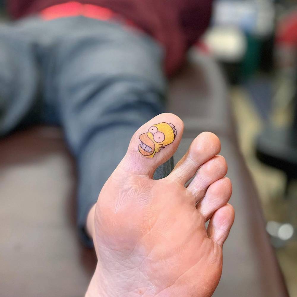 Homer Simpson portrait tattoo placed on the toe.