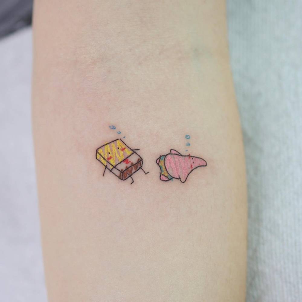 Cartoon style SpongeBob and Patrick tattoo located on the inner forearm.