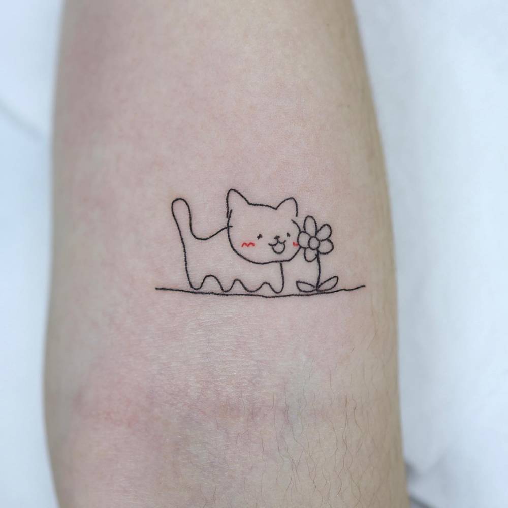 Ignorant style cat tattoo located on the inner forearm.