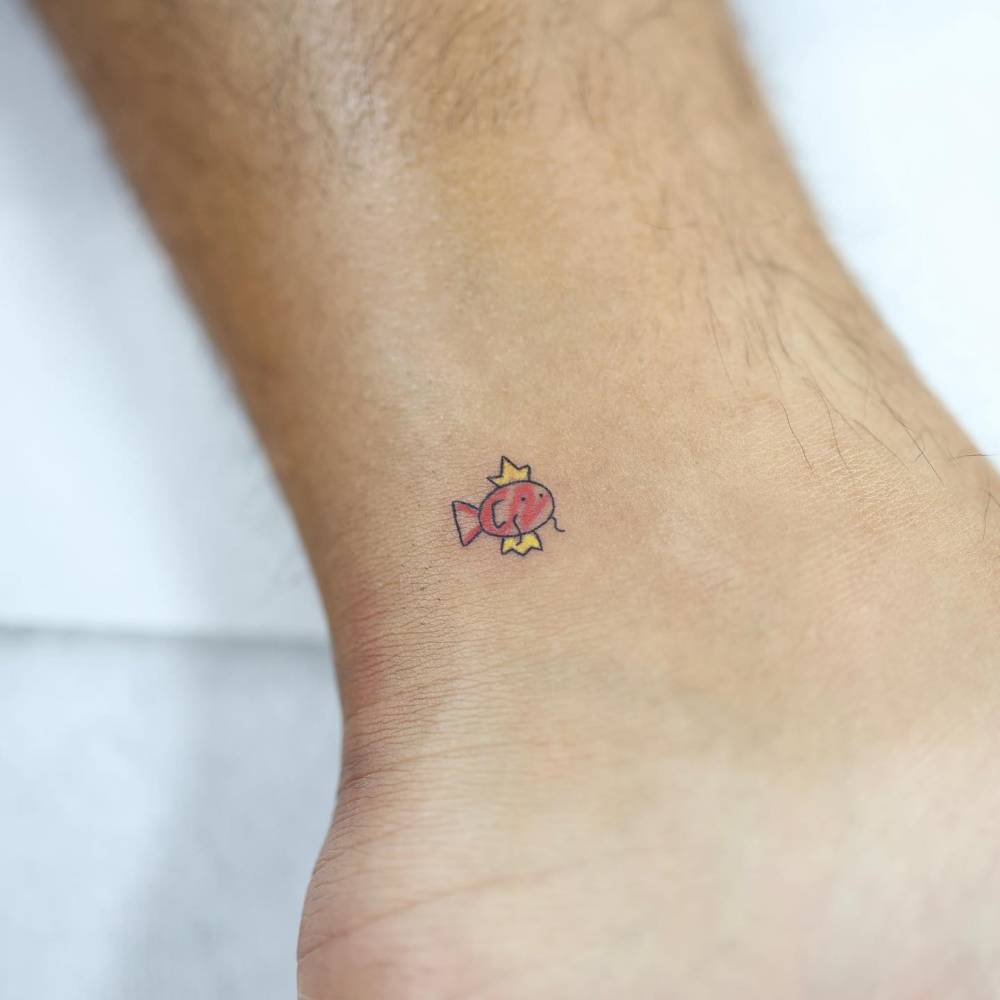 Tiny Magikarp tattoo located on the ankle.