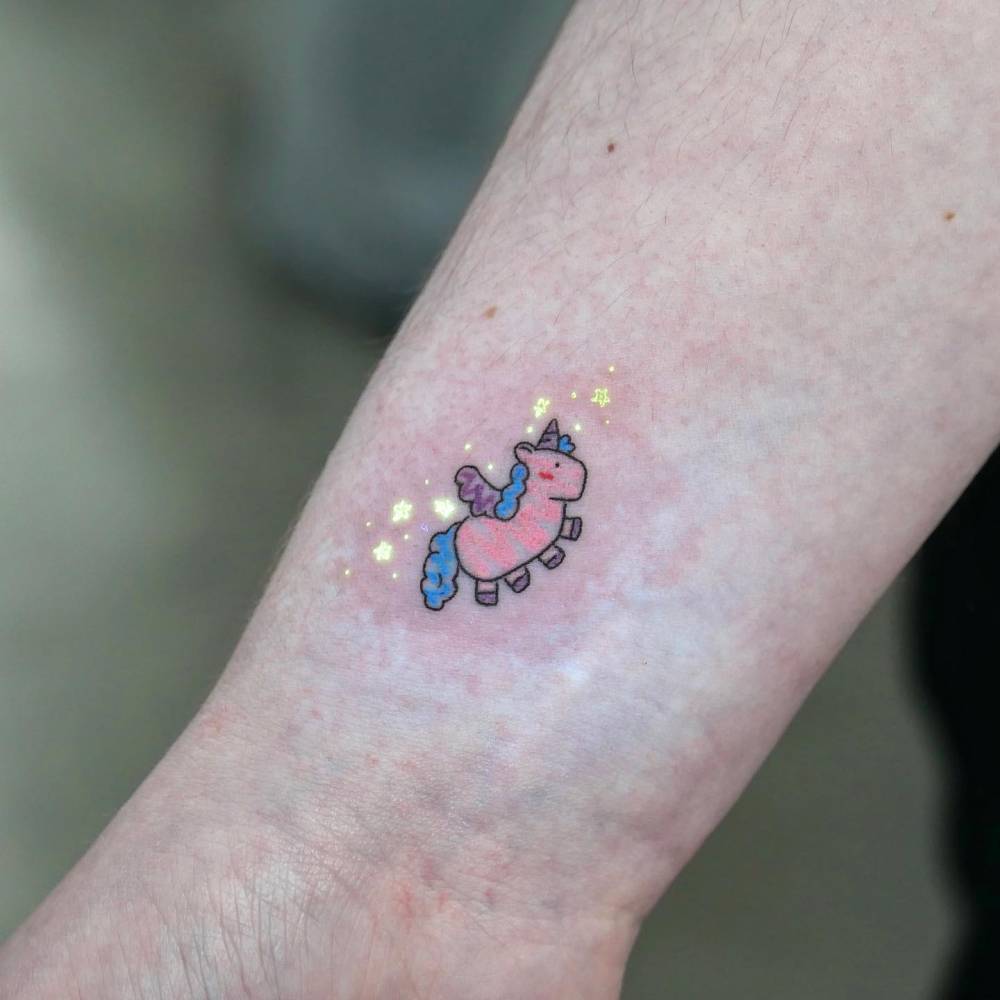 UV ink unicorn tattoo located on the wrist, cartoon style.