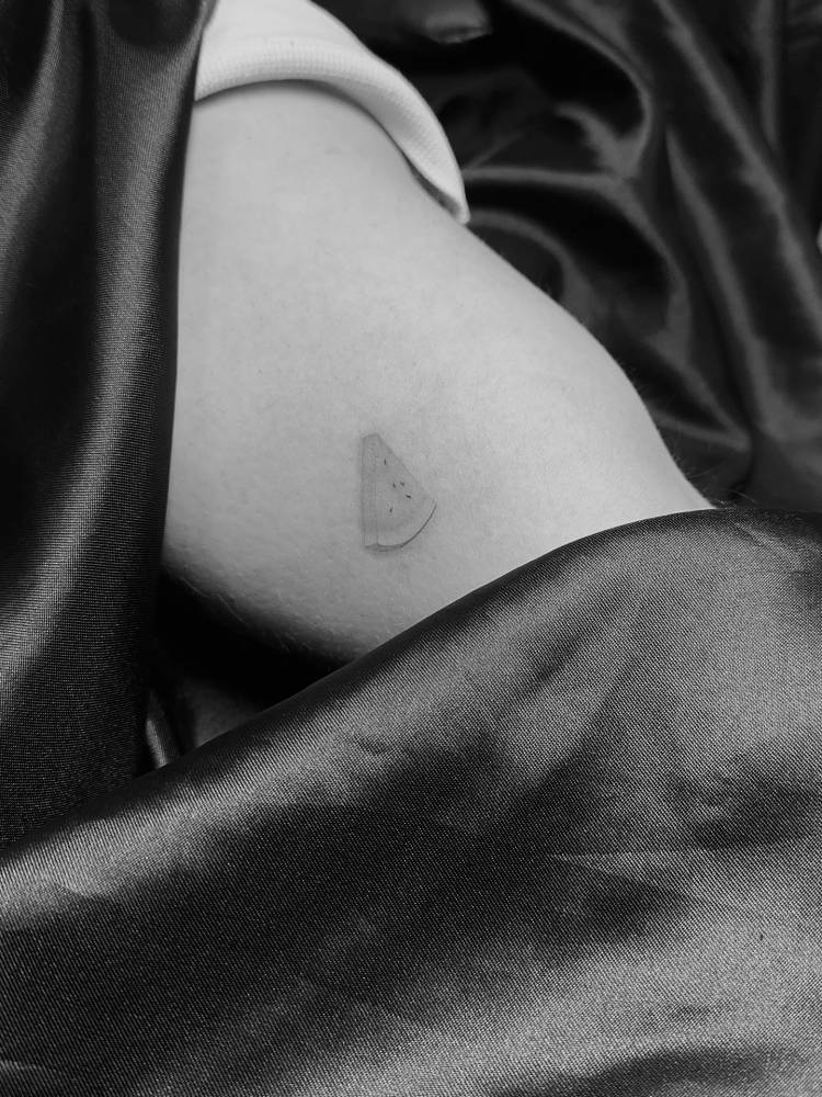 Illustrative style watermelon tattoo placed on the inner arm.
