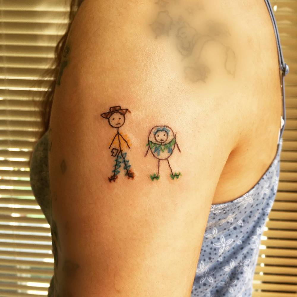 Ignorant style Woody and Buzz Lightyear tattoo located on the upper arm.