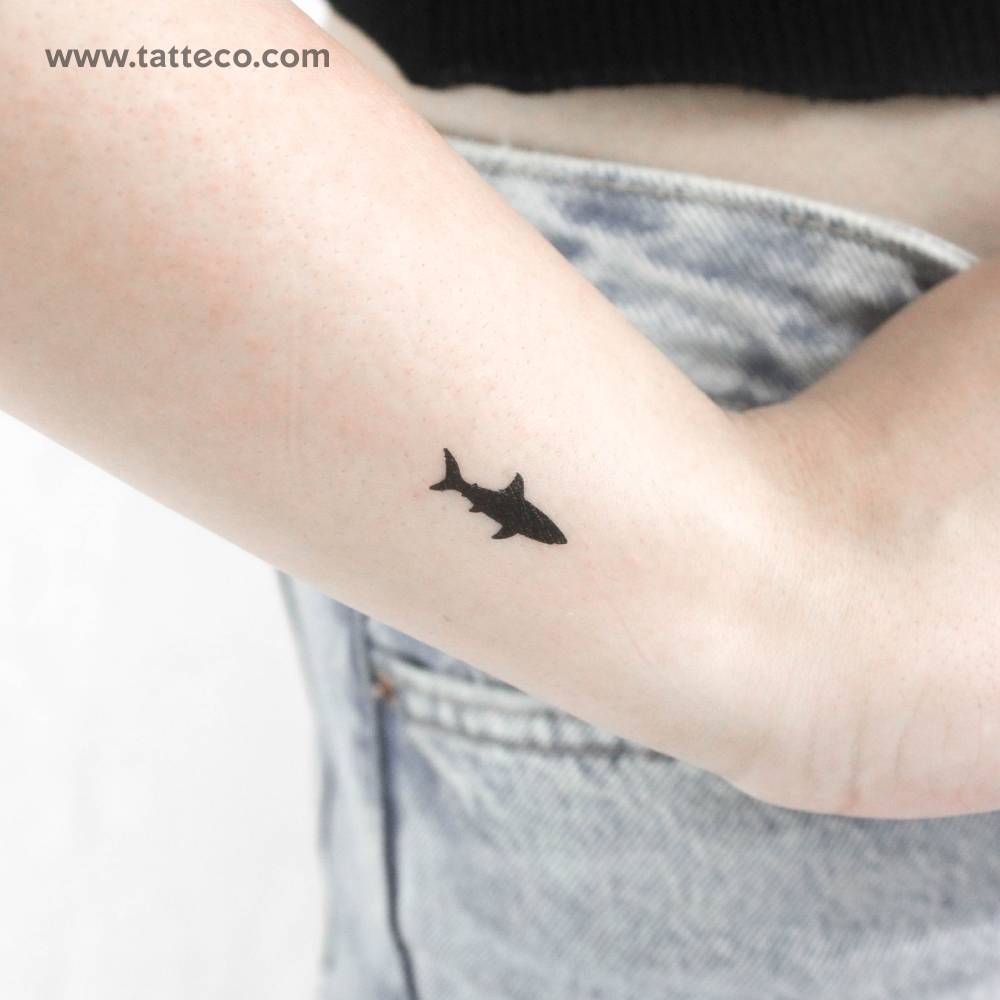 Black shark temporary tattoo located on the wrist.