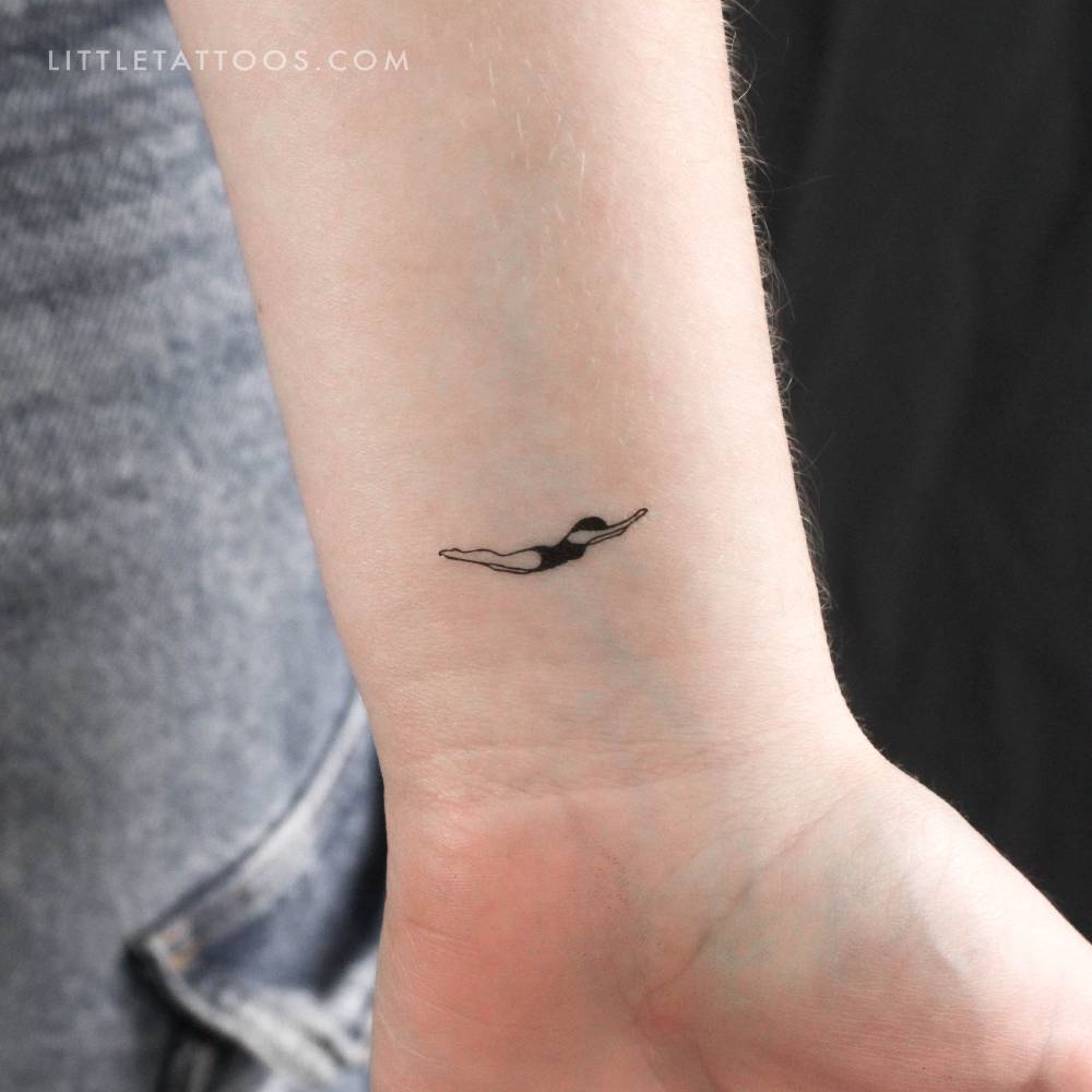 Minimalistic style swimmer temporary tattoo located on the wrist.