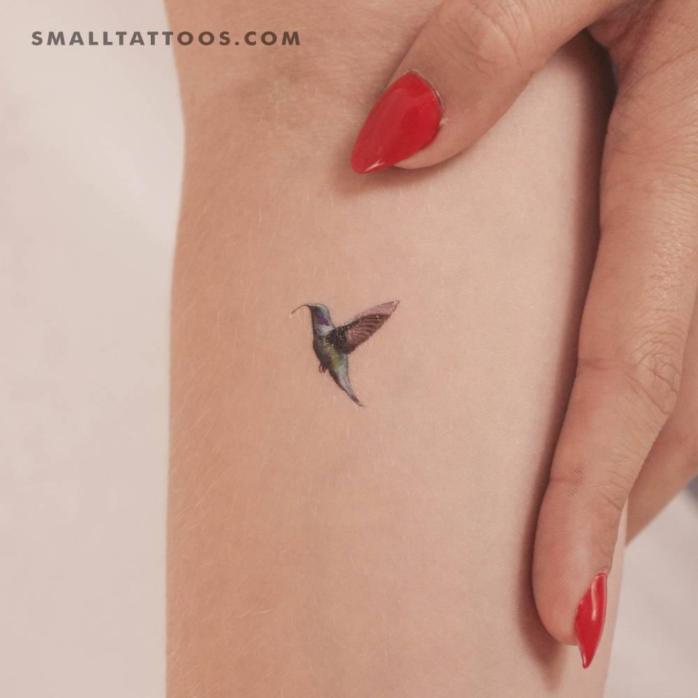 Micro-realistic hummingbird temporary tattoo located on the inner forearm.