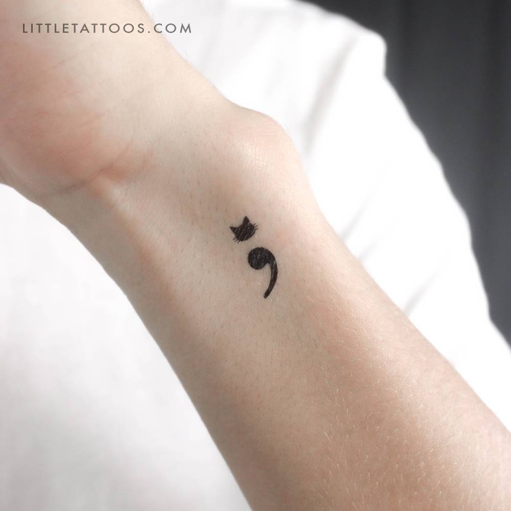 Semicolon cat temporary tattoo located on the wrist.