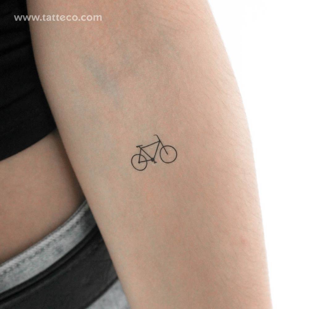 Minimalistic style ride bike temporary tattoo located on the inner forearm.