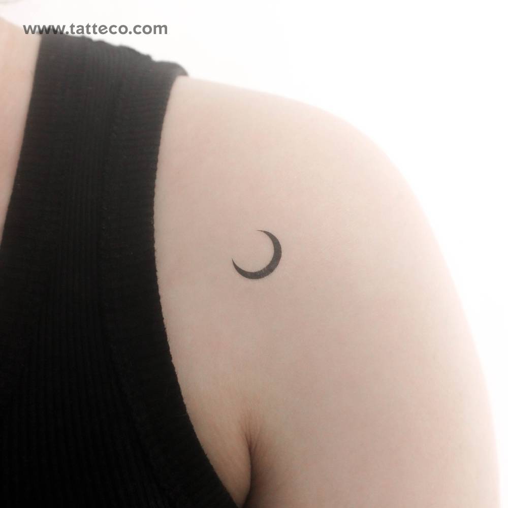 Minimalistic style crescent temporary tattoo located on the shoulder.
