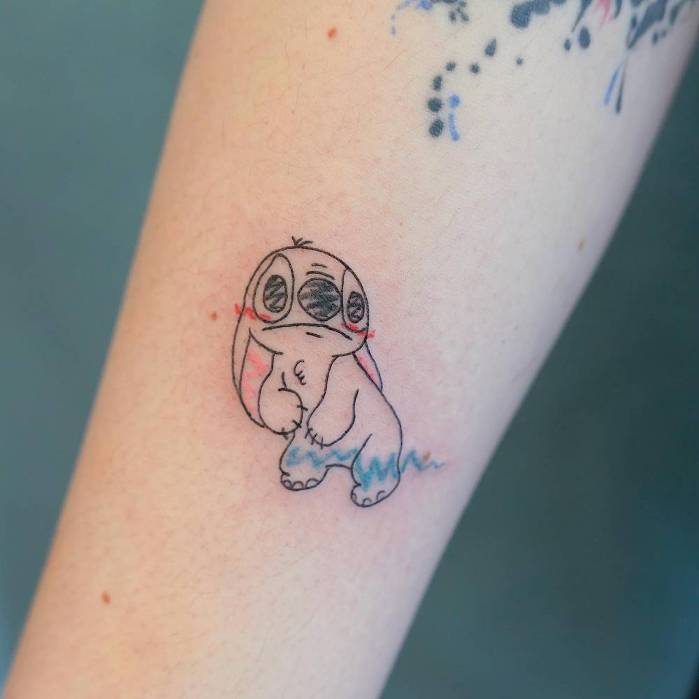 Stitch tattoo located on the forearm, done in ignorant style.