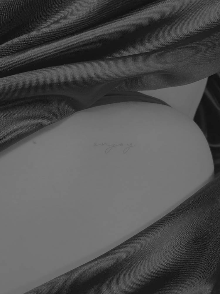Handwritten font word "enjoy" placed on the shoulder.