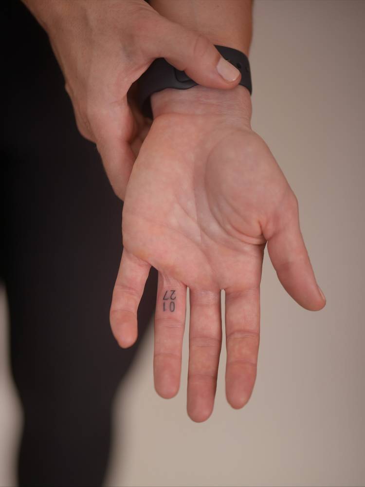 Small date tattoo located on the finger.