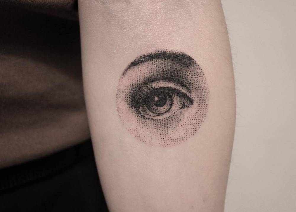 Fornasetti number 35 tattooed on the inner forearm.