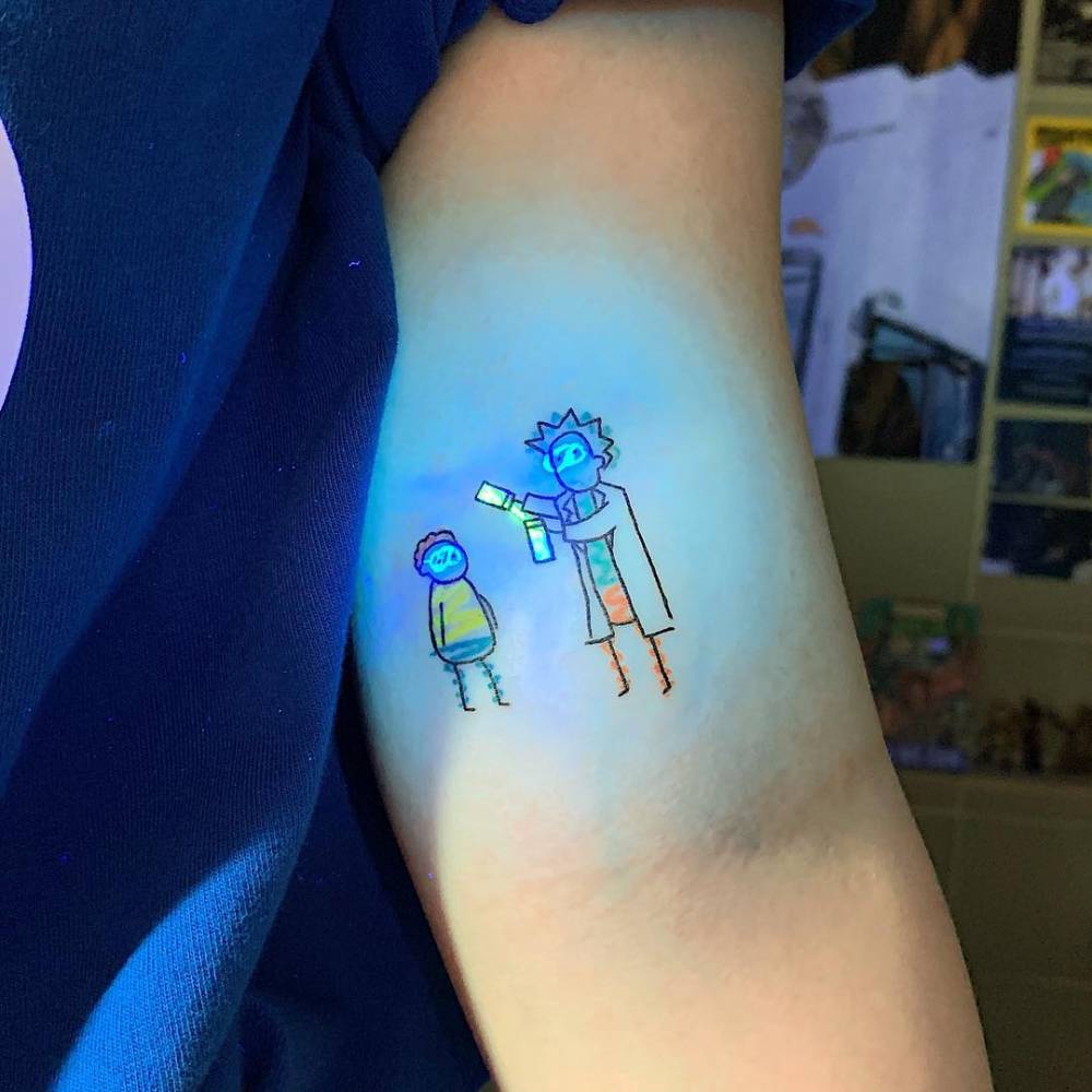 UV ink Rick and Morty tattoo done on the bicep.