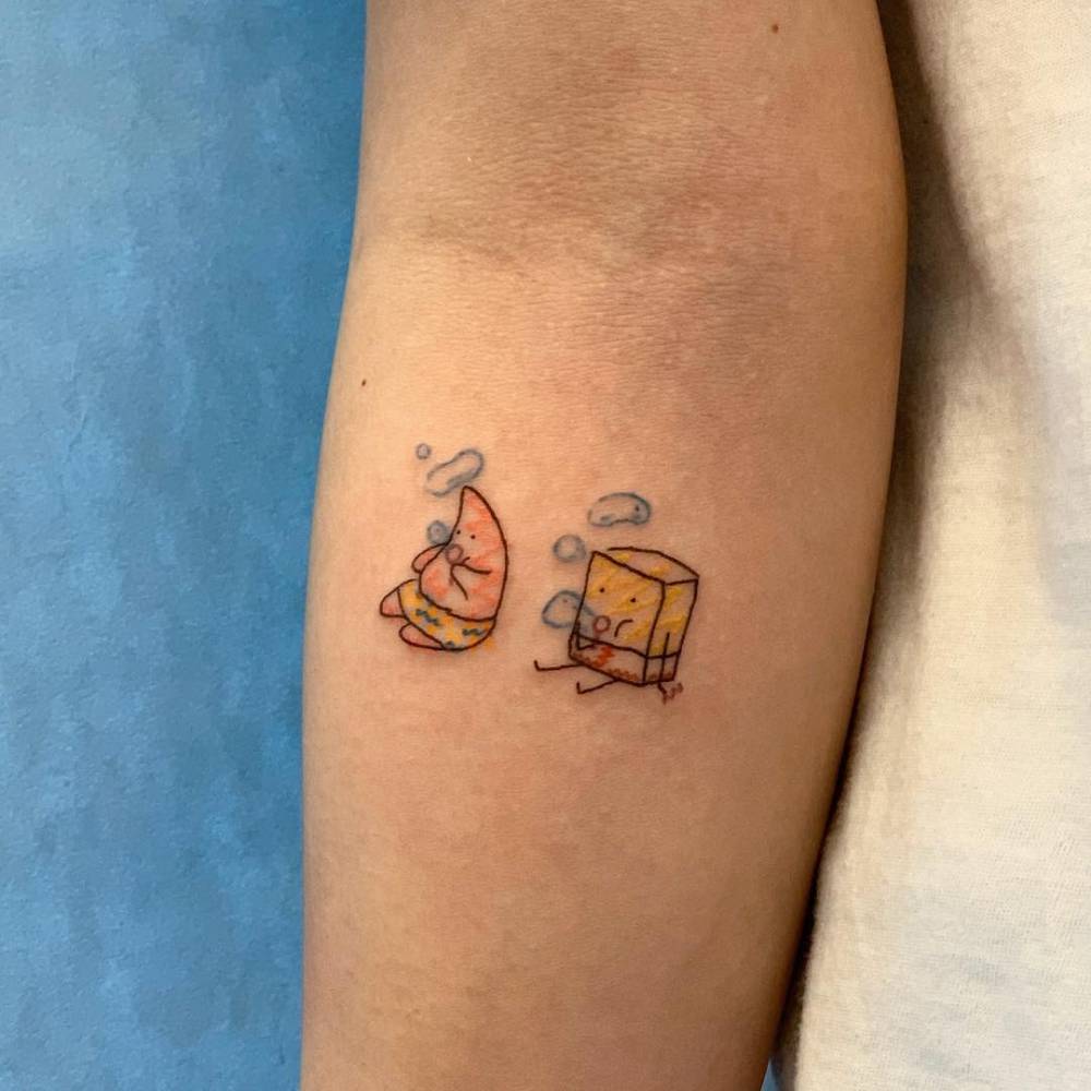 Patrick Star and Spongebob tattoo located on the inner forearm.
