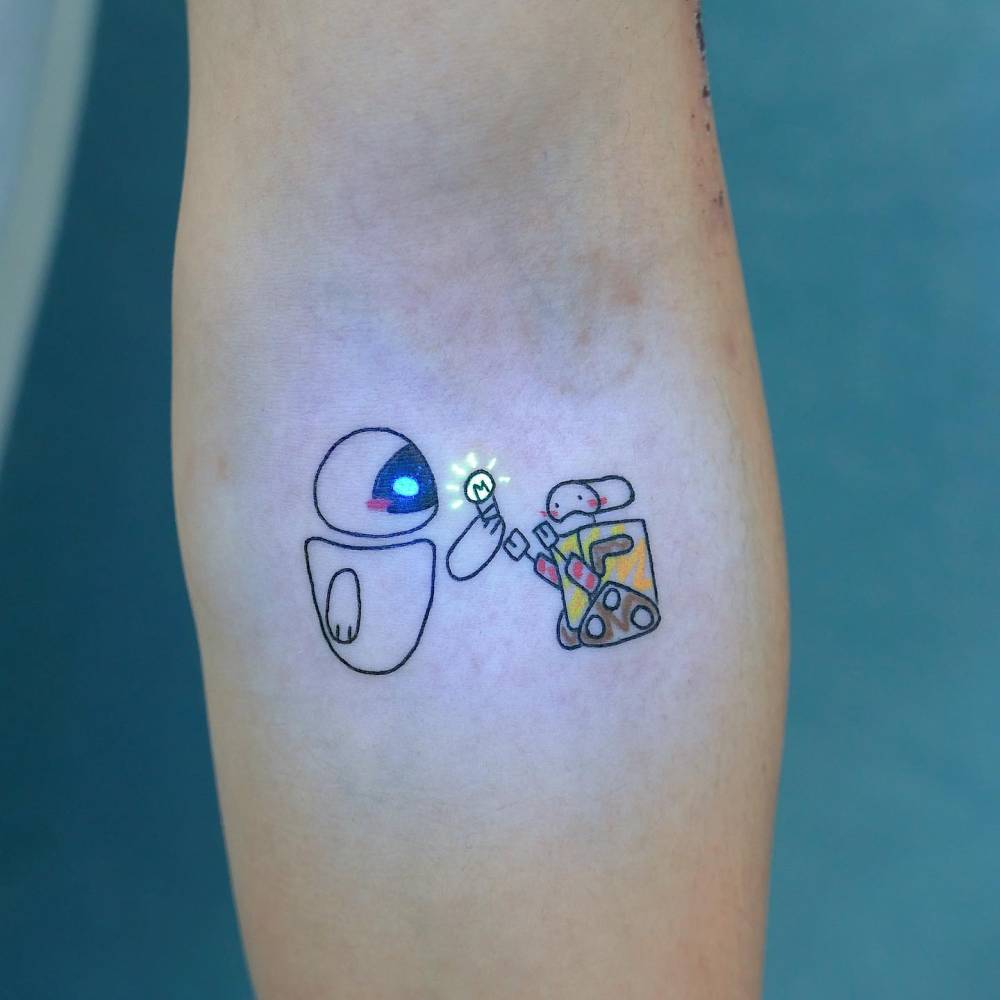 WALL-E tattoo in cartoon style located on the inner forearm.