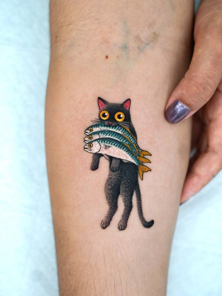 Cartoon style black cat eating three fish tattooed on the inner forearm.