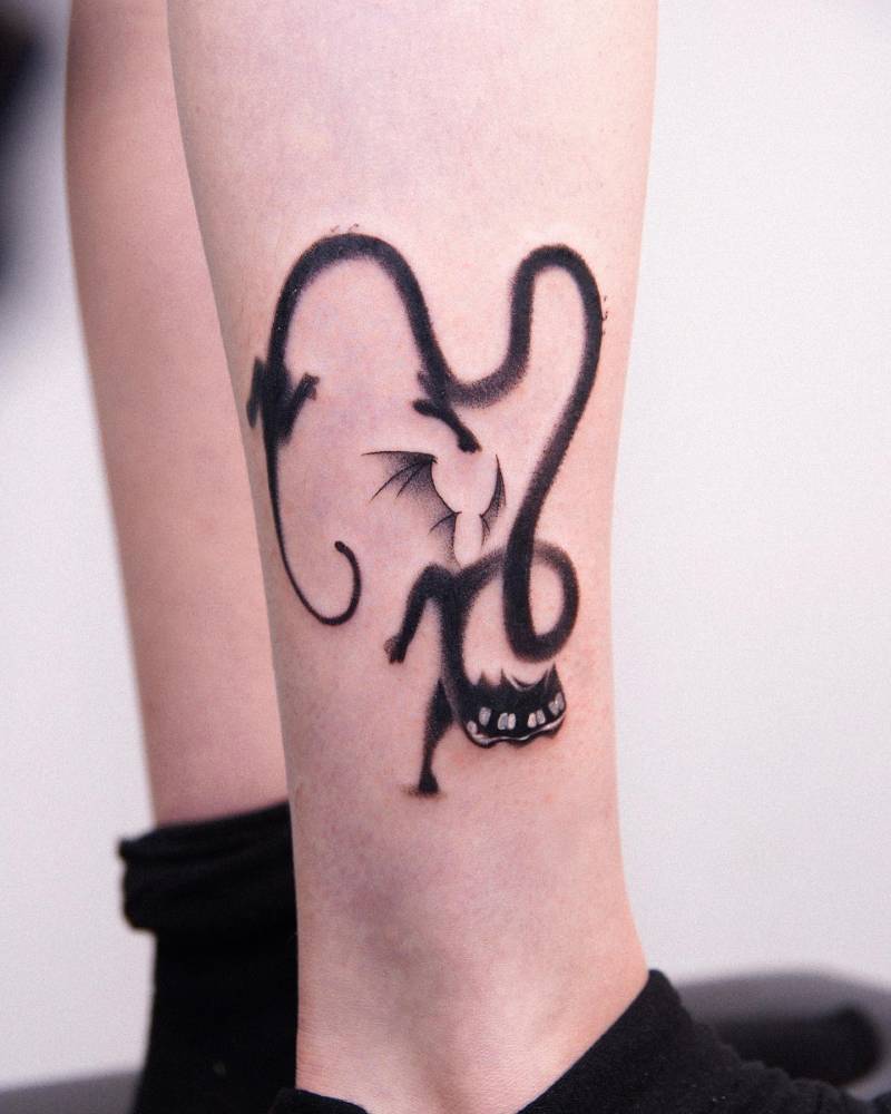 Dotwork style black cat devil tattooed on the shin.
