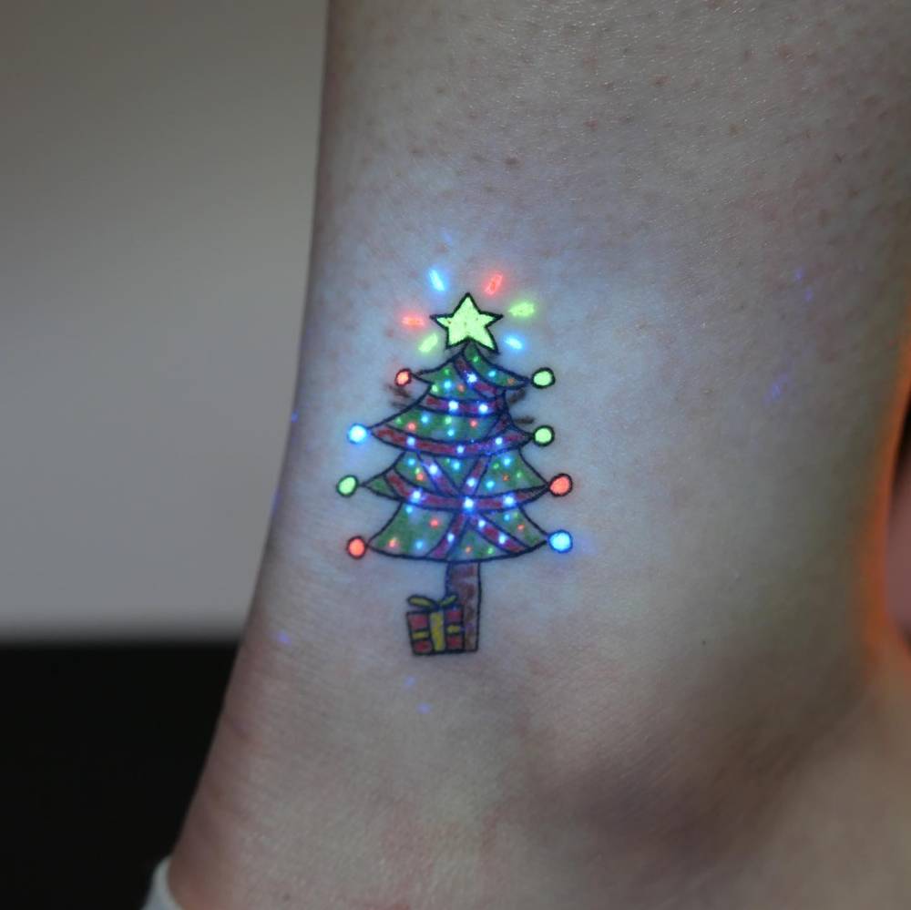 UV ink Christmas tree tattoo placed on the ankle.
