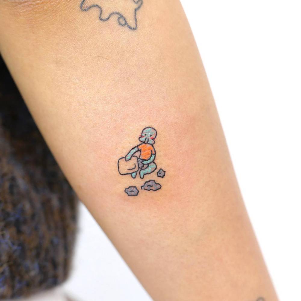 Cartoon style Squidward Tentacles tattoo located on the forearm.