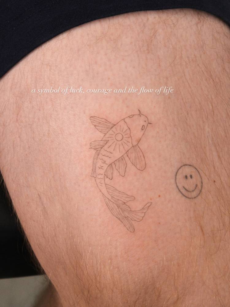 Koi fish tattoo in fine line style done on the thigh.