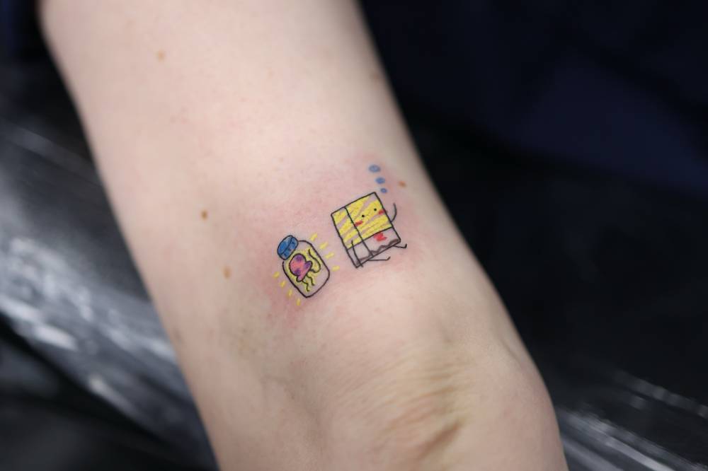 Ignorant style Spongebob tattoo done on the tricep.