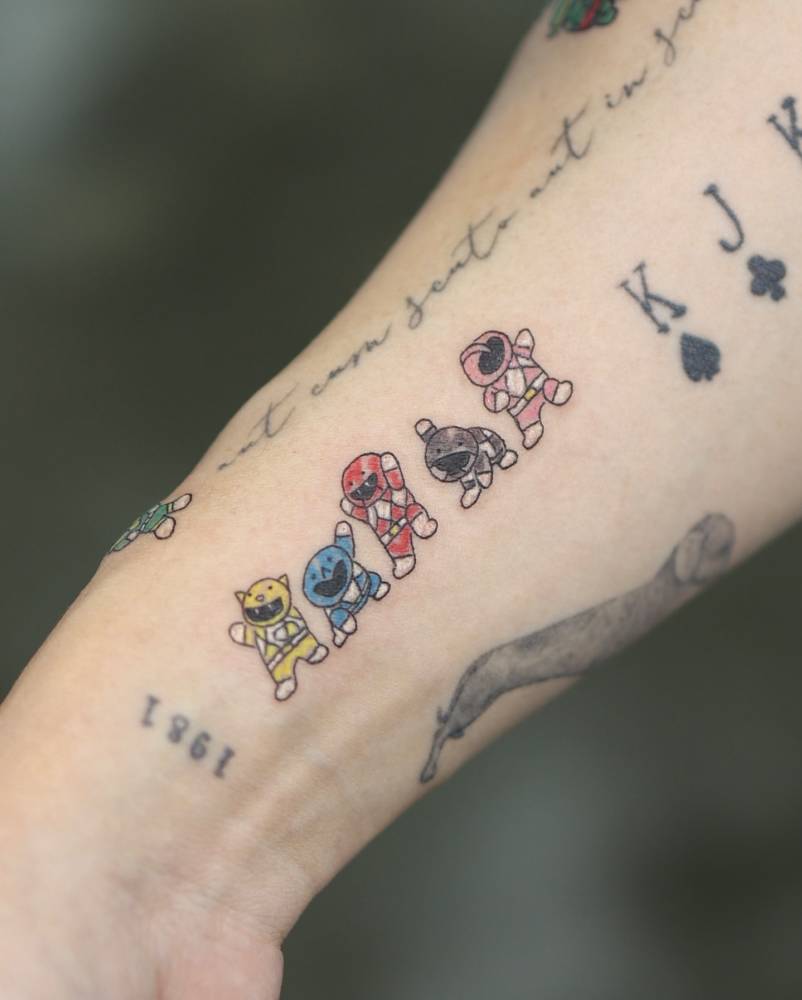 Power Rangers tattoo in cartoon style located on the wrist.