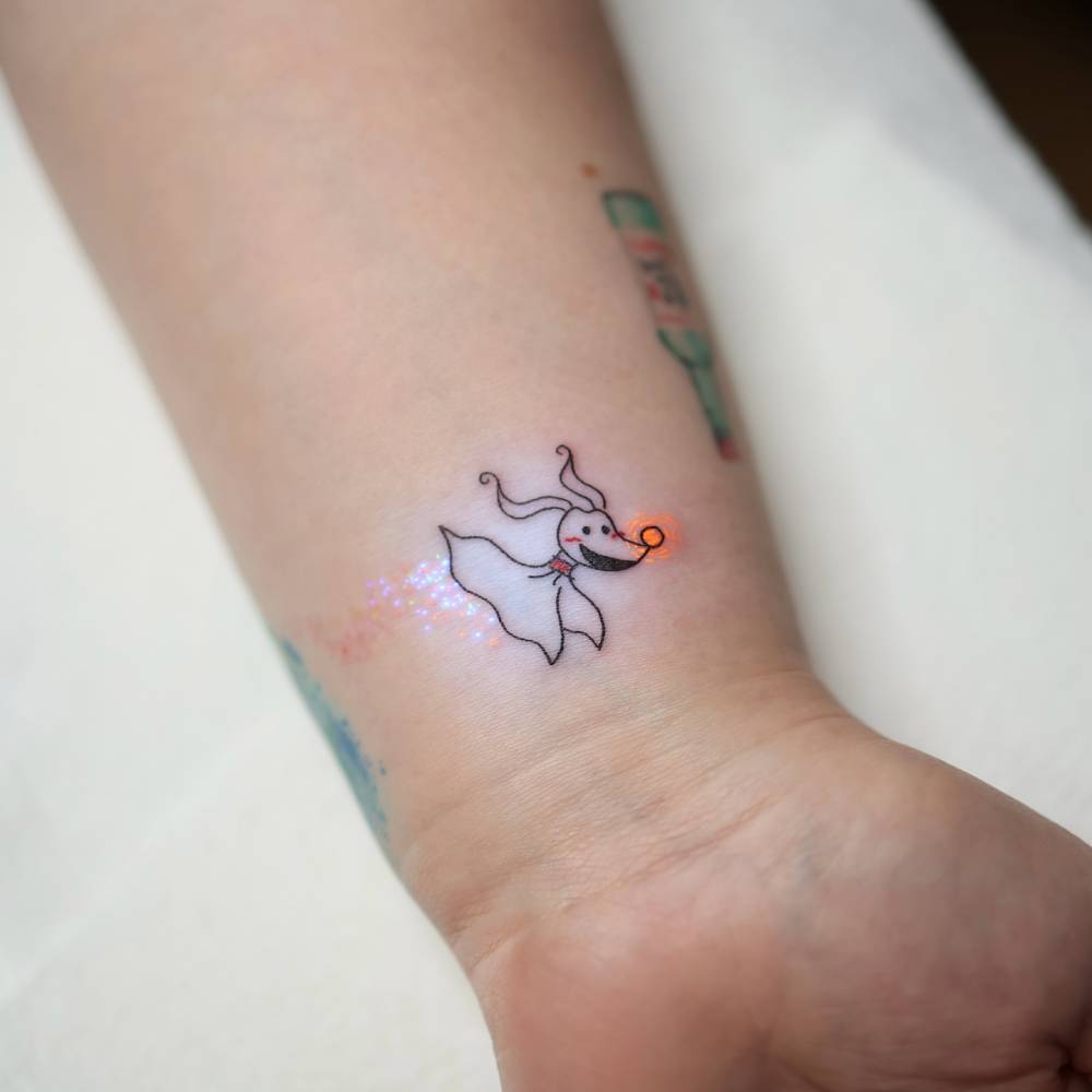 UV ink 'The Nightmare Before Christmas' tattoo located on the wrist.