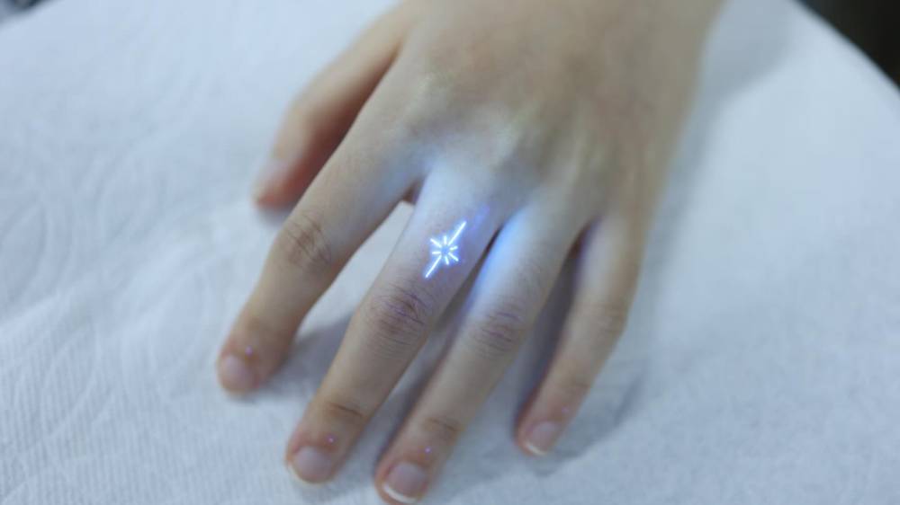 UV ink North Star tattoo located on the finger, minimalistic style.