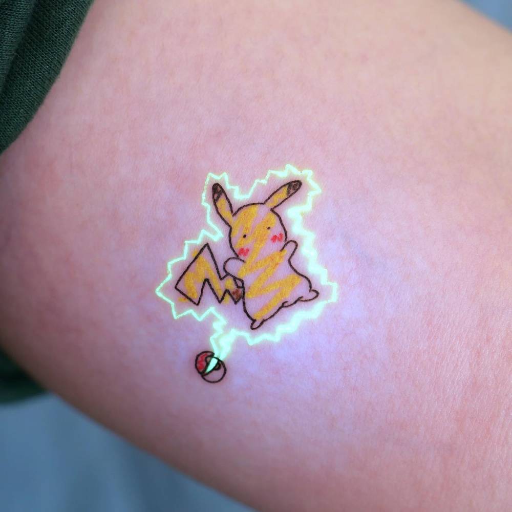 UV ink Pikachu tattoo done on the inner arm.