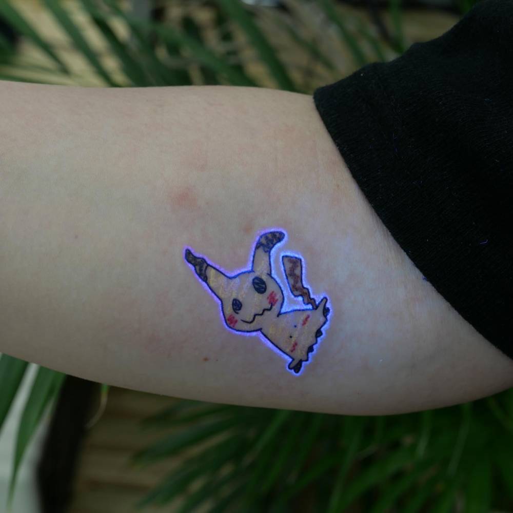 Ignorant style Pikachu tattoo in UV ink located on the inner forearm.