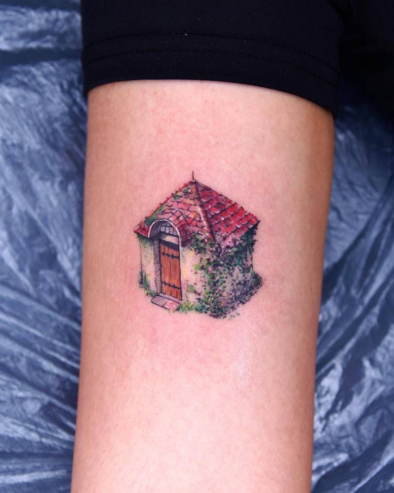 Howl's Moving Castle tattoo located on the bicep, watercolor style.