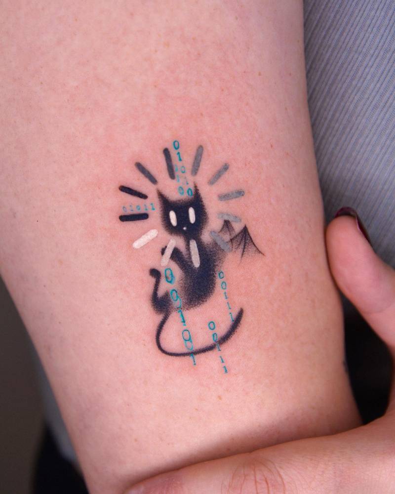 Cute devil cat tattoo located on the upper arm, pop art style.