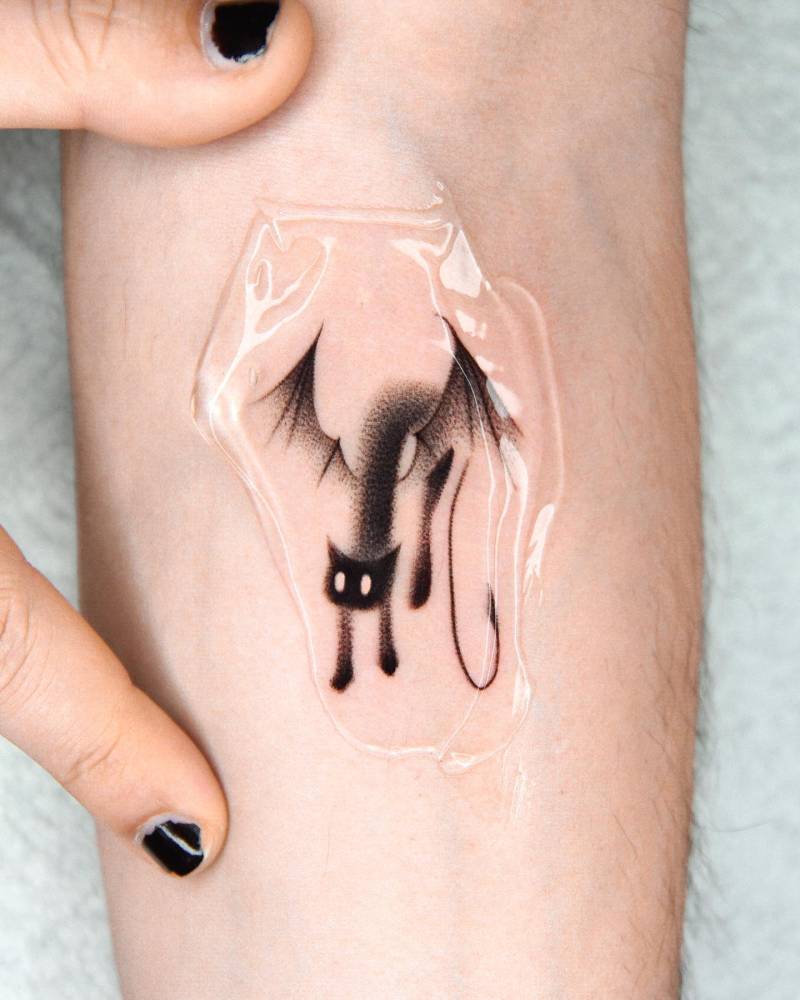 Dotwork style devil cat tattoo located on the inner forearm.