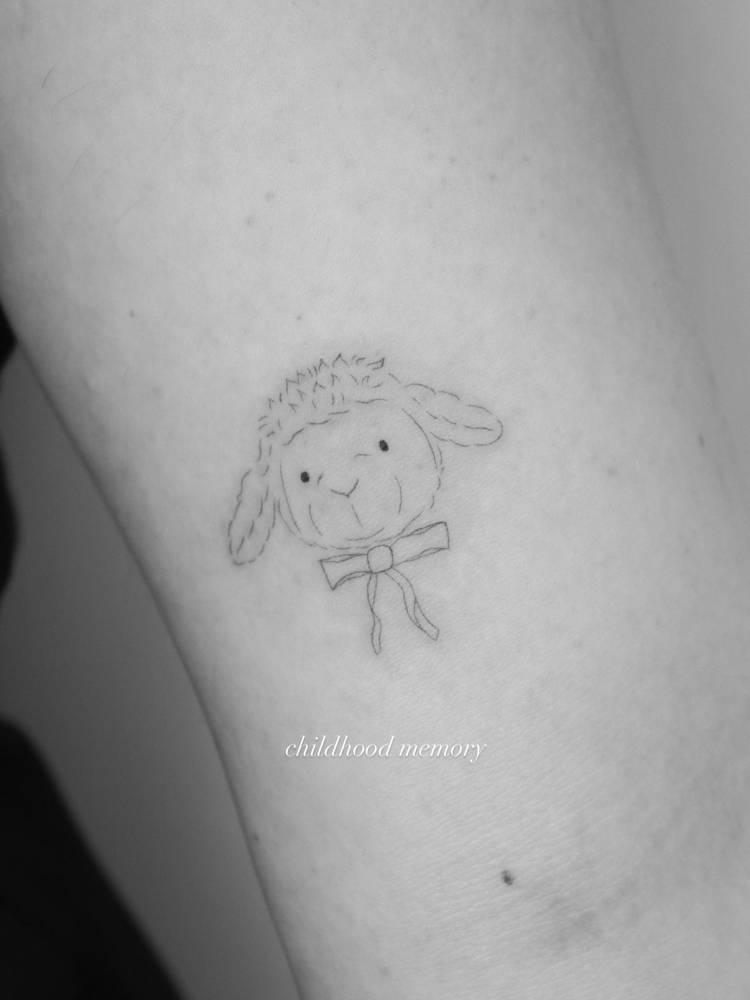 Lamb portrait tattoo in fine line style located on the inner arm.