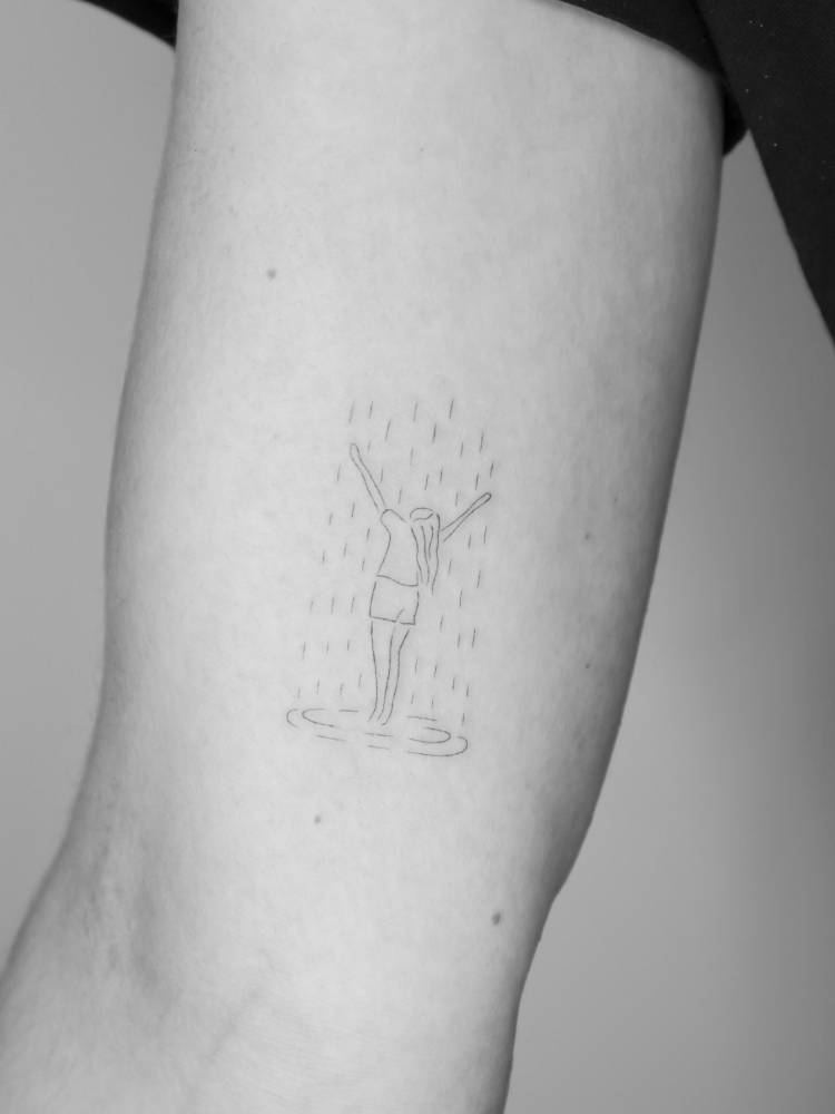Rain tattoo in fine line style located on the inner arm.
