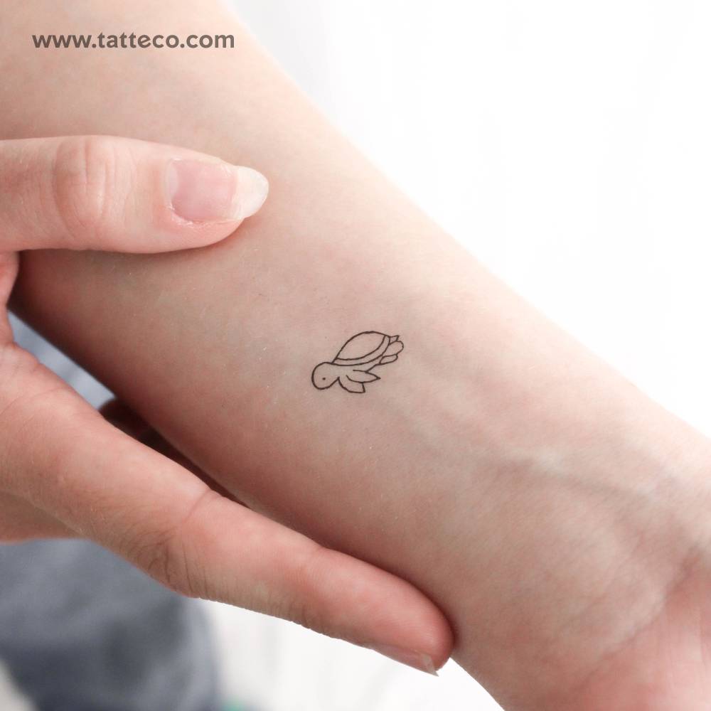 Minimalistic style tiny turtle temporary tattoo placed on the wrist.