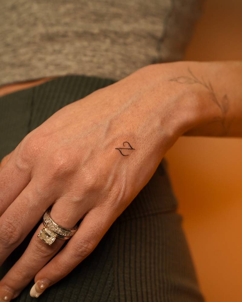 Tiny letter "Z" tattoo placed on the hand.