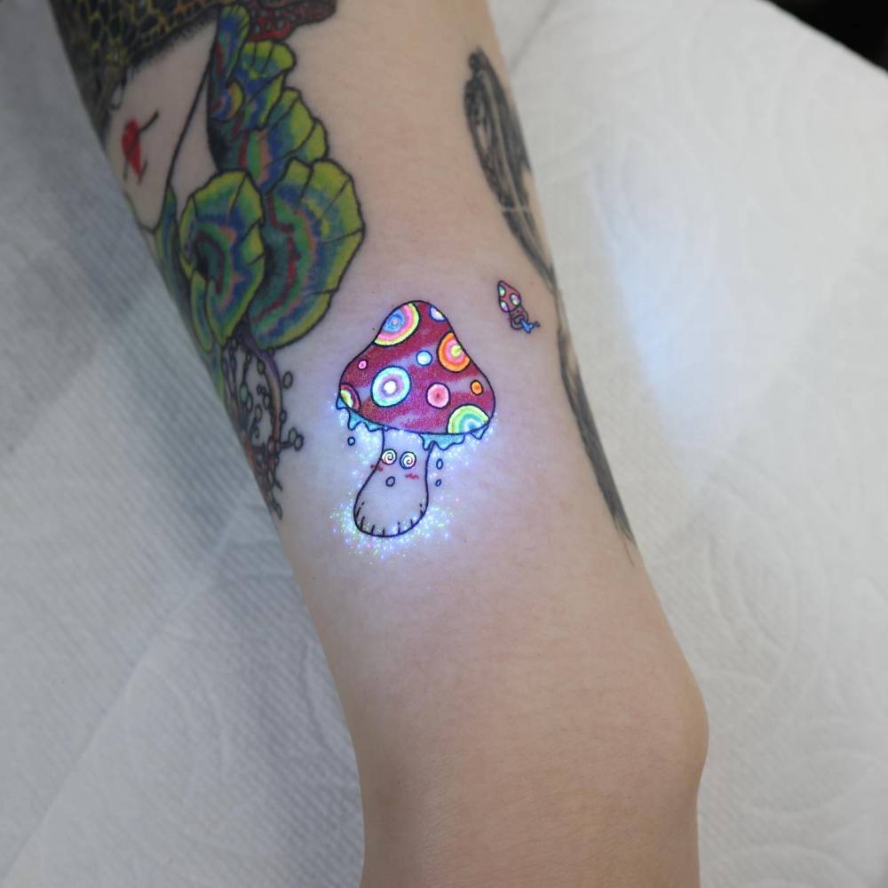 Psychedelic mushroom tattoo located on the inner arm.