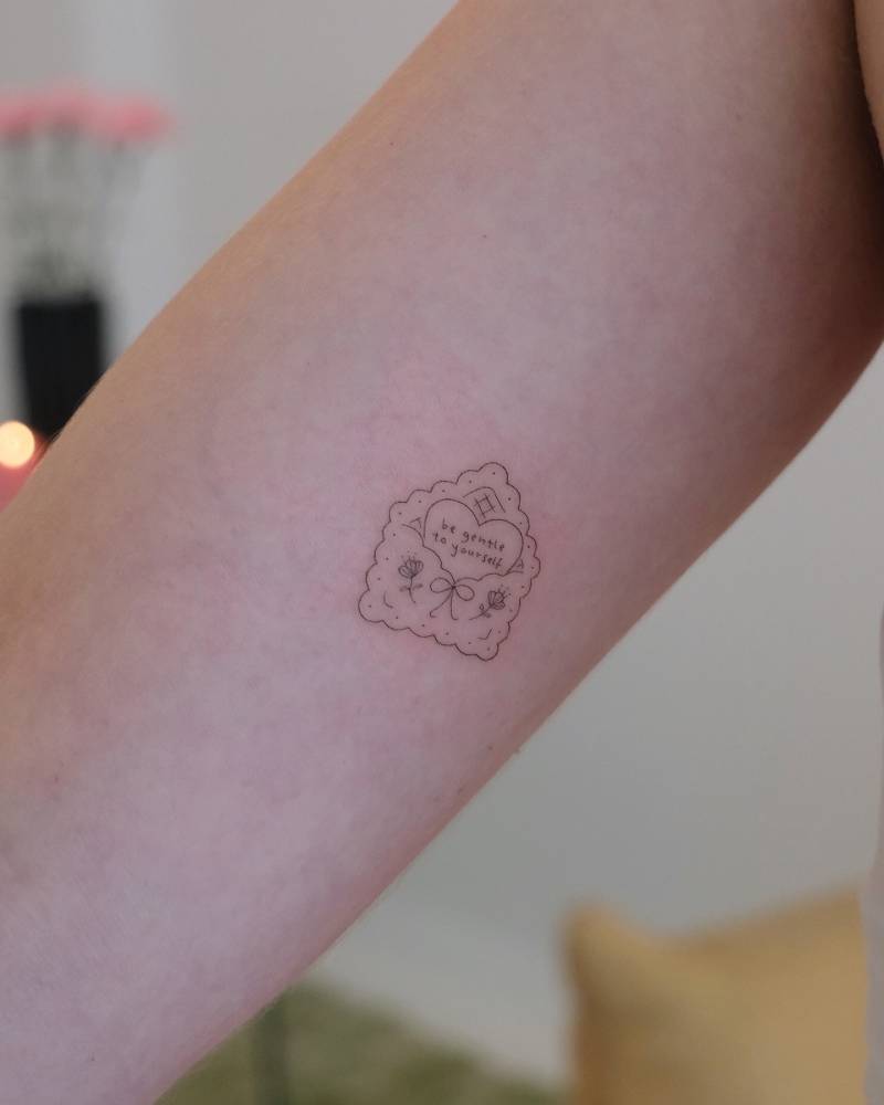 Love letter tattoo in fine line style placed on the inner arm.