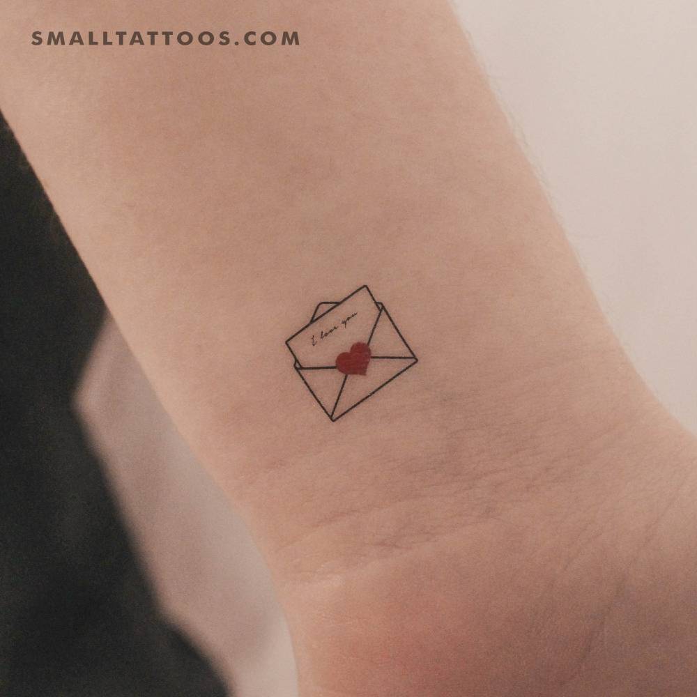 Open love letter temporary tattoo located on the wrist.