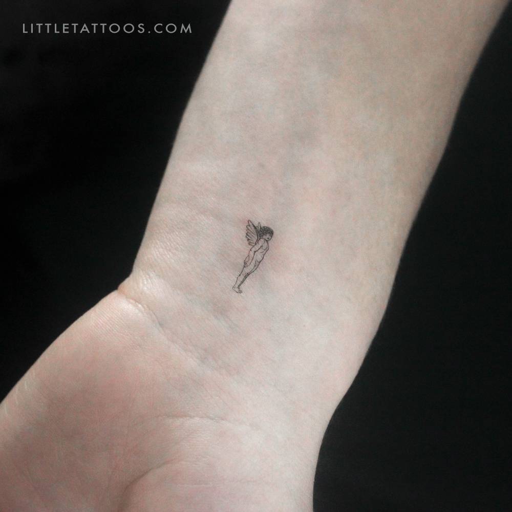 Tiny angel temporary tattoo located on the wrist.