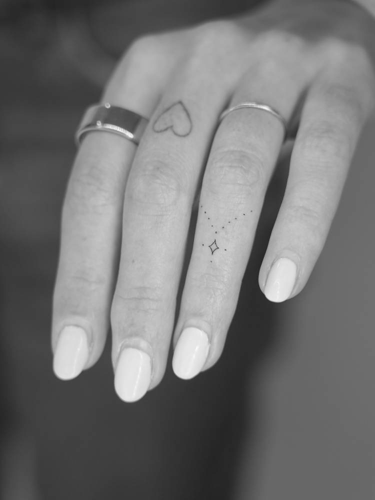 Little ornamental design tattooed on the finger.