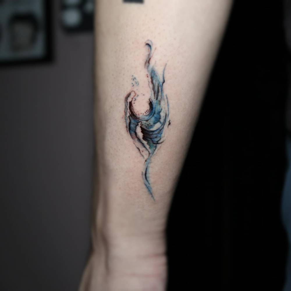 Wave tattoo in illustrative style placed on the wrist.