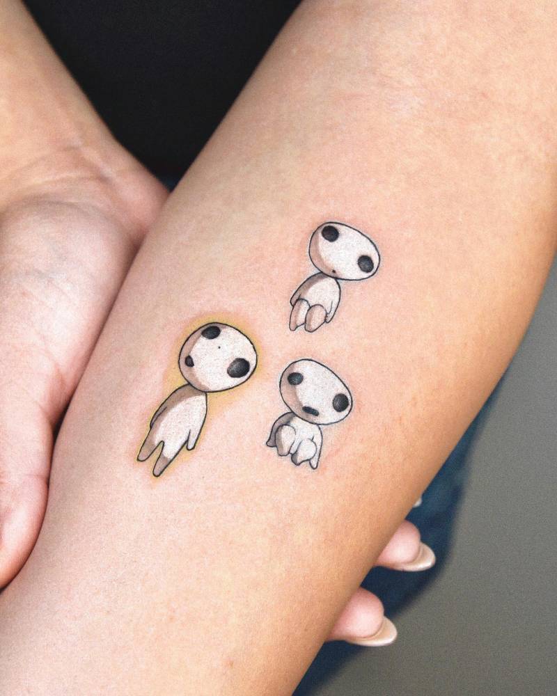 Cartoon style Kodama tattoo located on the inner forearm.