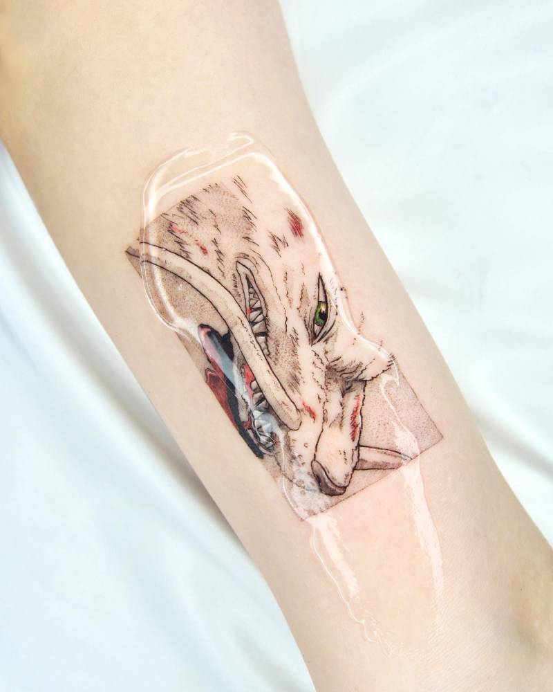 Cartoon style Haku portrait tattoo located on the inner arm.